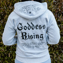 Load image into Gallery viewer, The back of the gray Emerald Hearth Zip Up Hoodie which says the words Goddess Rising in the center.  It has the logo underneath and features a spider web detail on the hood.