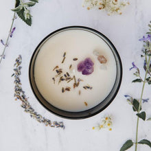 Load image into Gallery viewer, View of the top of the Bewitching Breeze candle by Emerald Hearth.  The candle has amethyst, lavender quartz, and lavender on top.