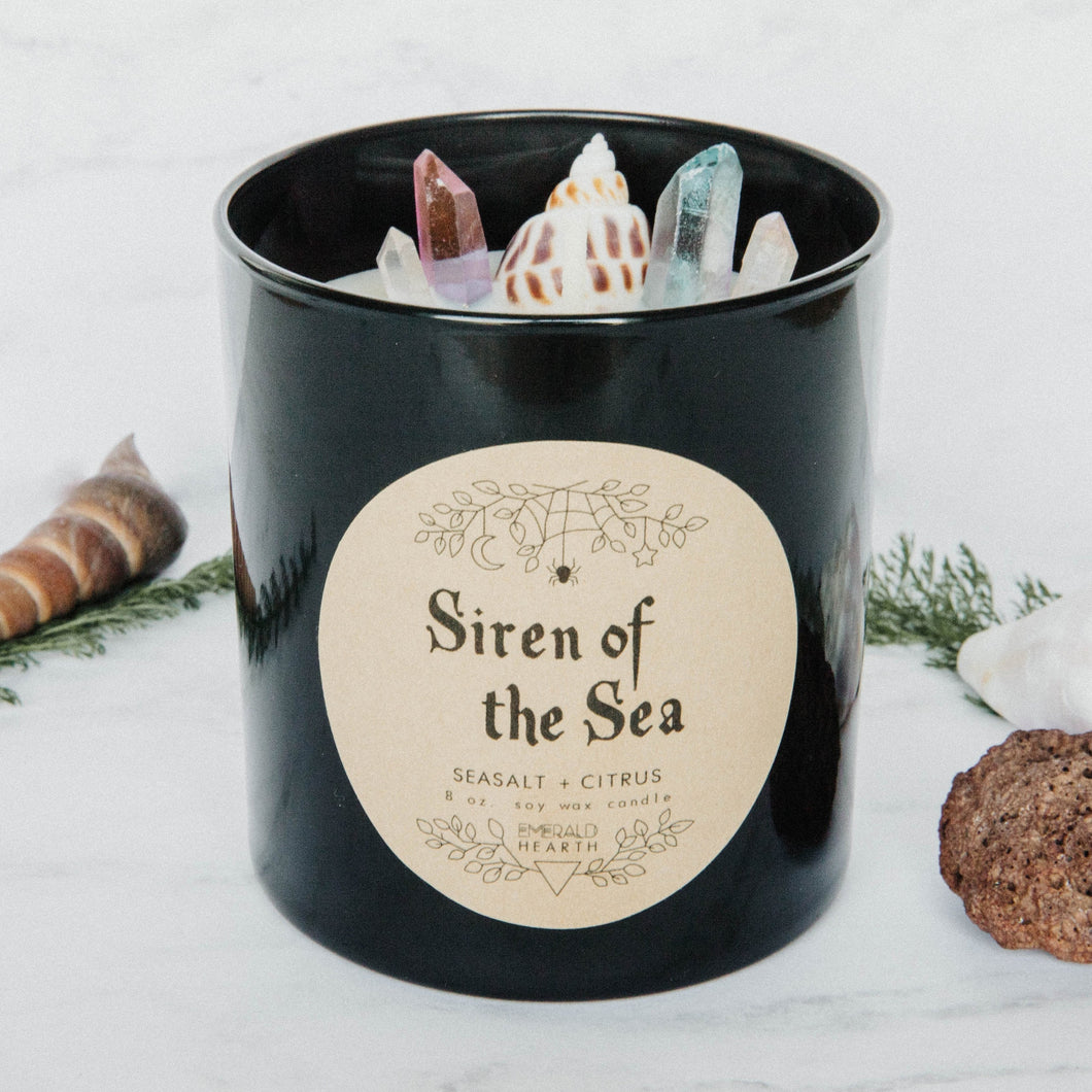 Image of the Siren of the Sea candle by Emerald Hearth.  This candle has bits of quartz and a seashell on the top.