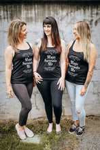 Load image into Gallery viewer, Three women wearing black Emerald Hearth tank tops that says Magic Surrounds Me.