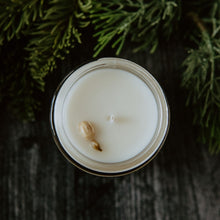 Load image into Gallery viewer, The top of the Emerald Hearth mini original candle which has a jasmine bud on top.