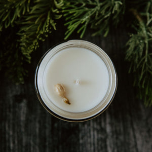 The top of the Emerald Hearth mini original candle which has a jasmine bud on top.