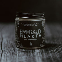 Load image into Gallery viewer, The mini Emerald Hearth original candle photographed on wood with a black background.