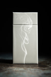Side view of the Lemon and Oak scented matchsticks.  There is also a puff of smoke in front.