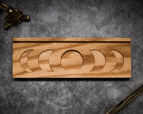 Aerial of the Mini Moon Tray by Emerald Hearth.  This moon tray is made of wood.  The center of it has a full moon and then there are two crescent moons on either side opening towards the center.