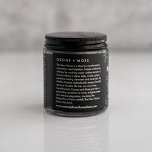Load image into Gallery viewer, Back view of the New Moon Muse candle by Emerald Hearth.  The candle has black packaging.