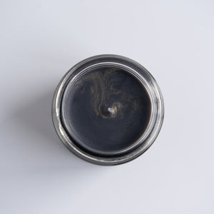 Aerial view of the New Moon Muse candle which has golden sparkles on the top.